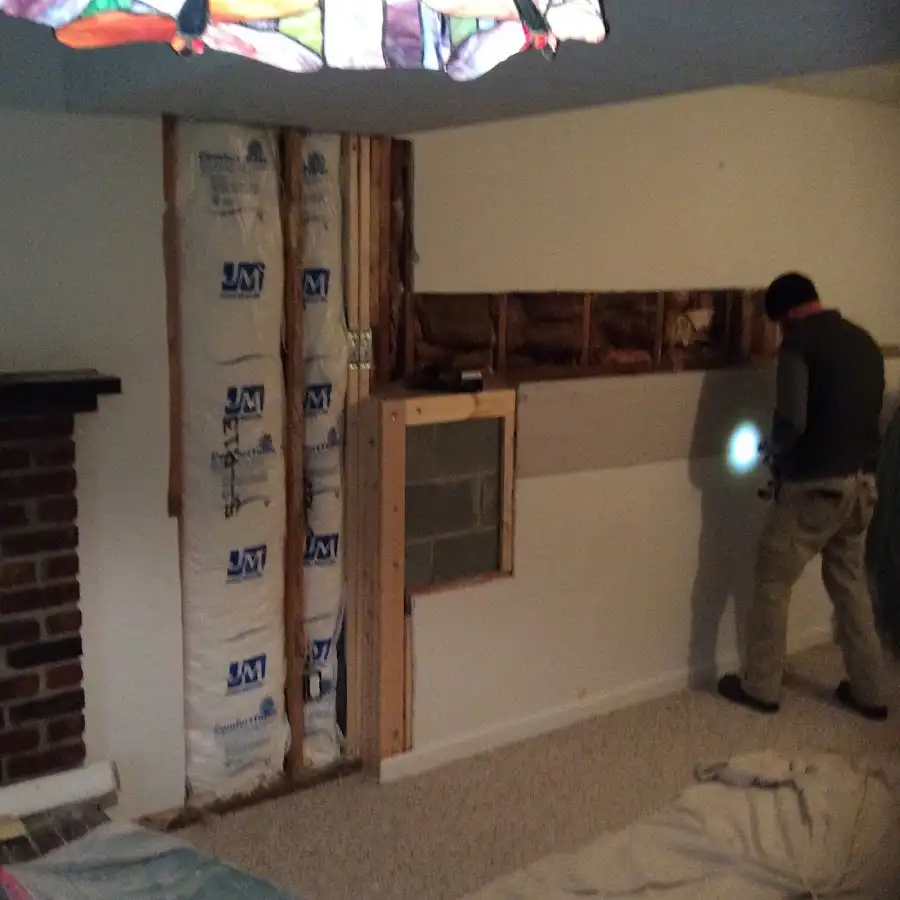 Restoration technician inspecting water damage in Defiance